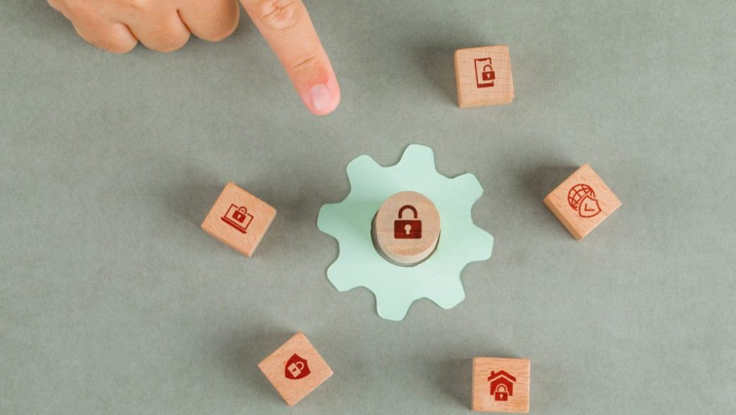 conceptual-of-data-privacy-man-hand-pointing-with-wooden-blocks-paper-settings-icon (1)